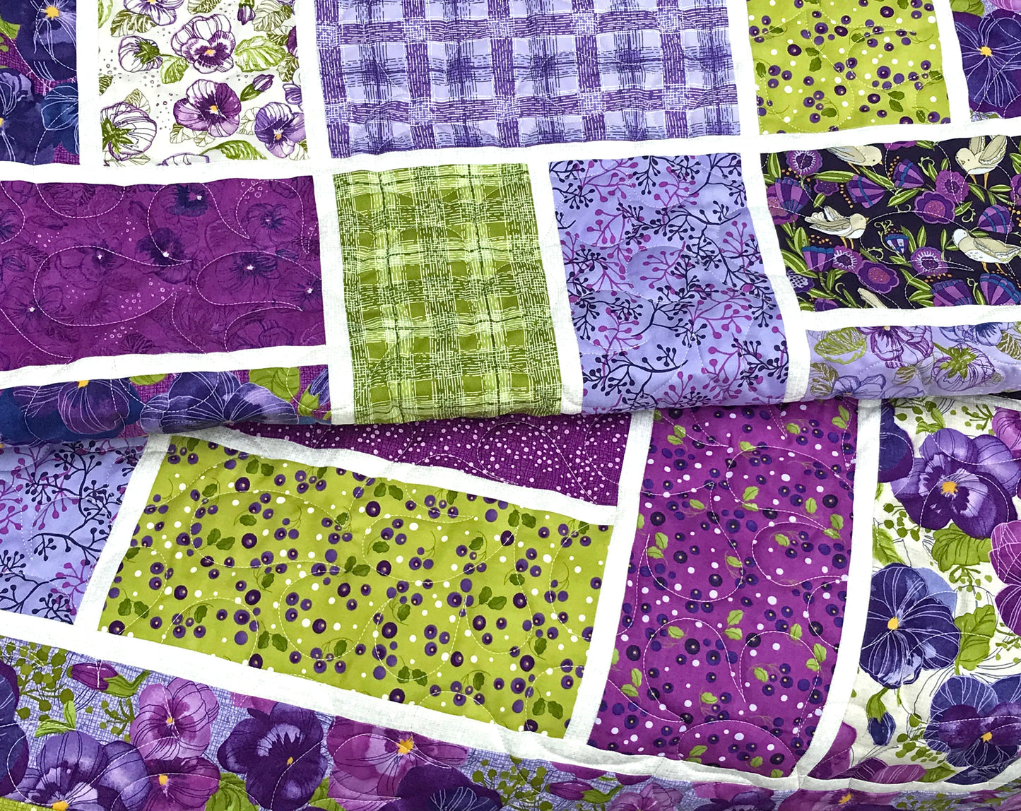 close up of purple and green large block quilt made from Bricktown quilt pattern