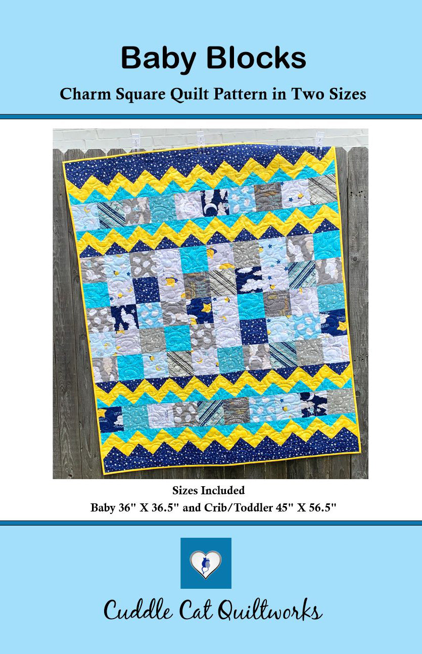 attern front cover of Baby Blocks, a charm square baby quilt pattern with yellow top and bottom zig-zag rows that look like rick-rack with rows of patchwork squares in between. Quilt is trimmed in blue and yellow and yellow.