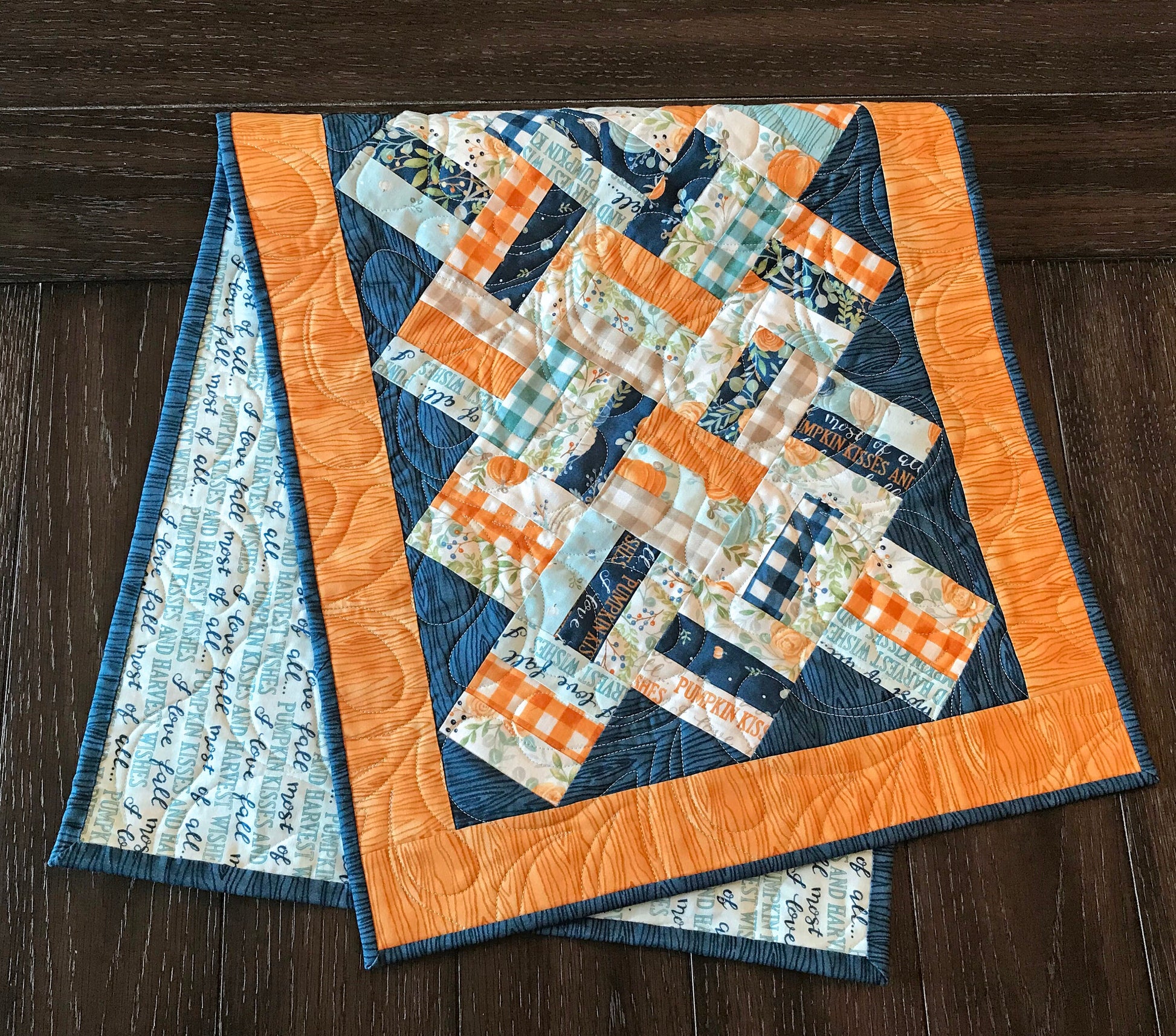 Braided Squares table runner and topper pattern. Sample runner and topper shown with a fall color scheme of dark blue, aqua, cream and orange.