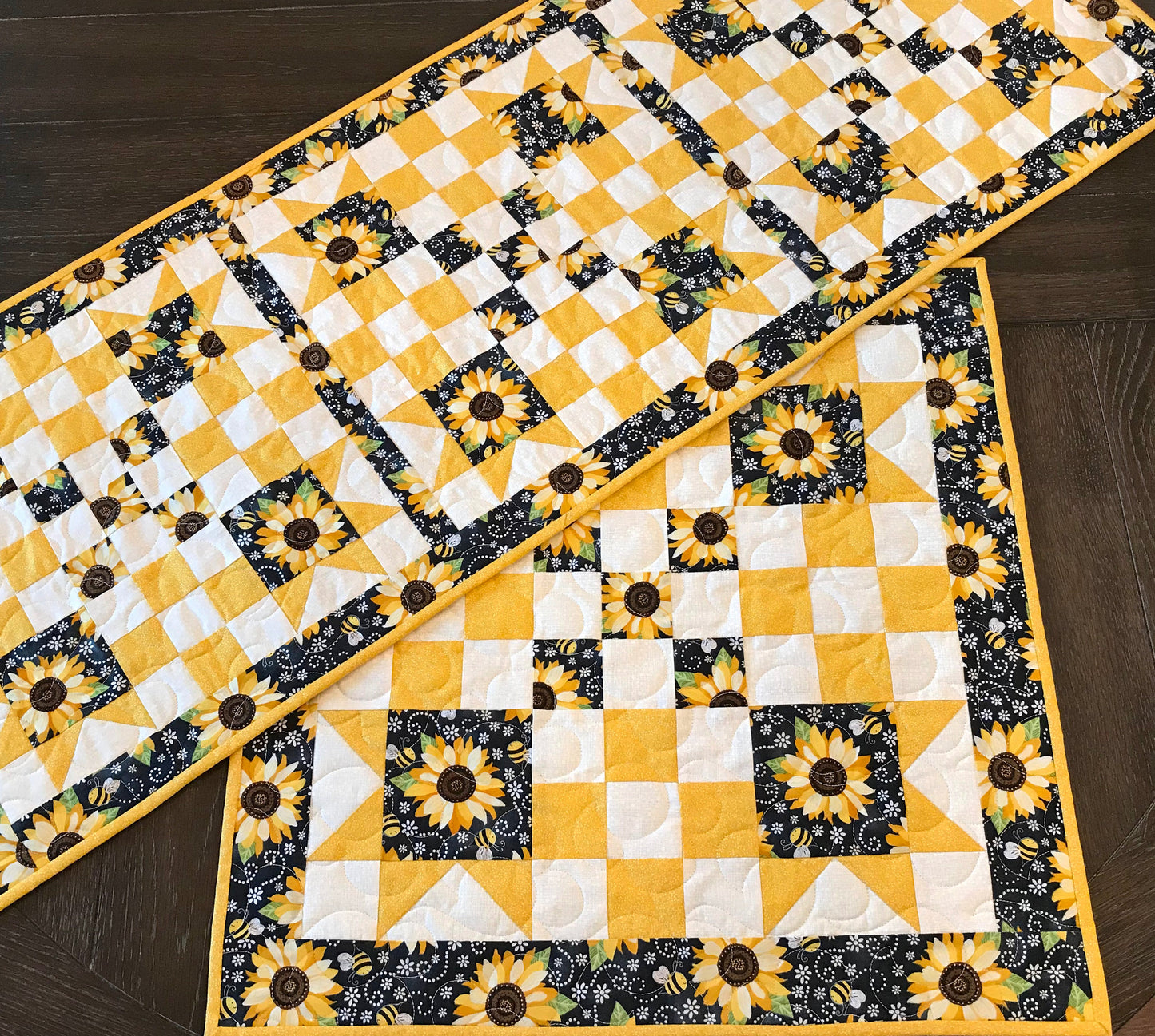 runner and topper displayed on a table for pattern for a table runner or table topper that has sawtooth star corner units with nine patch blocks in between.