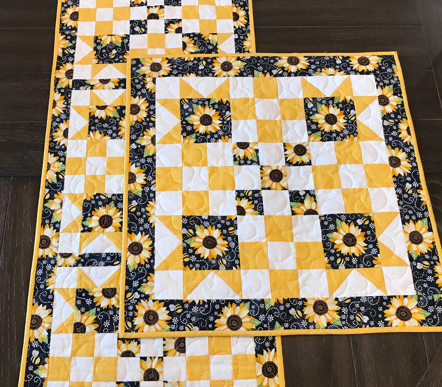 topper and runner on a table for pattern for a table runner or table topper that has sawtooth star corner units with nine patch blocks in between.