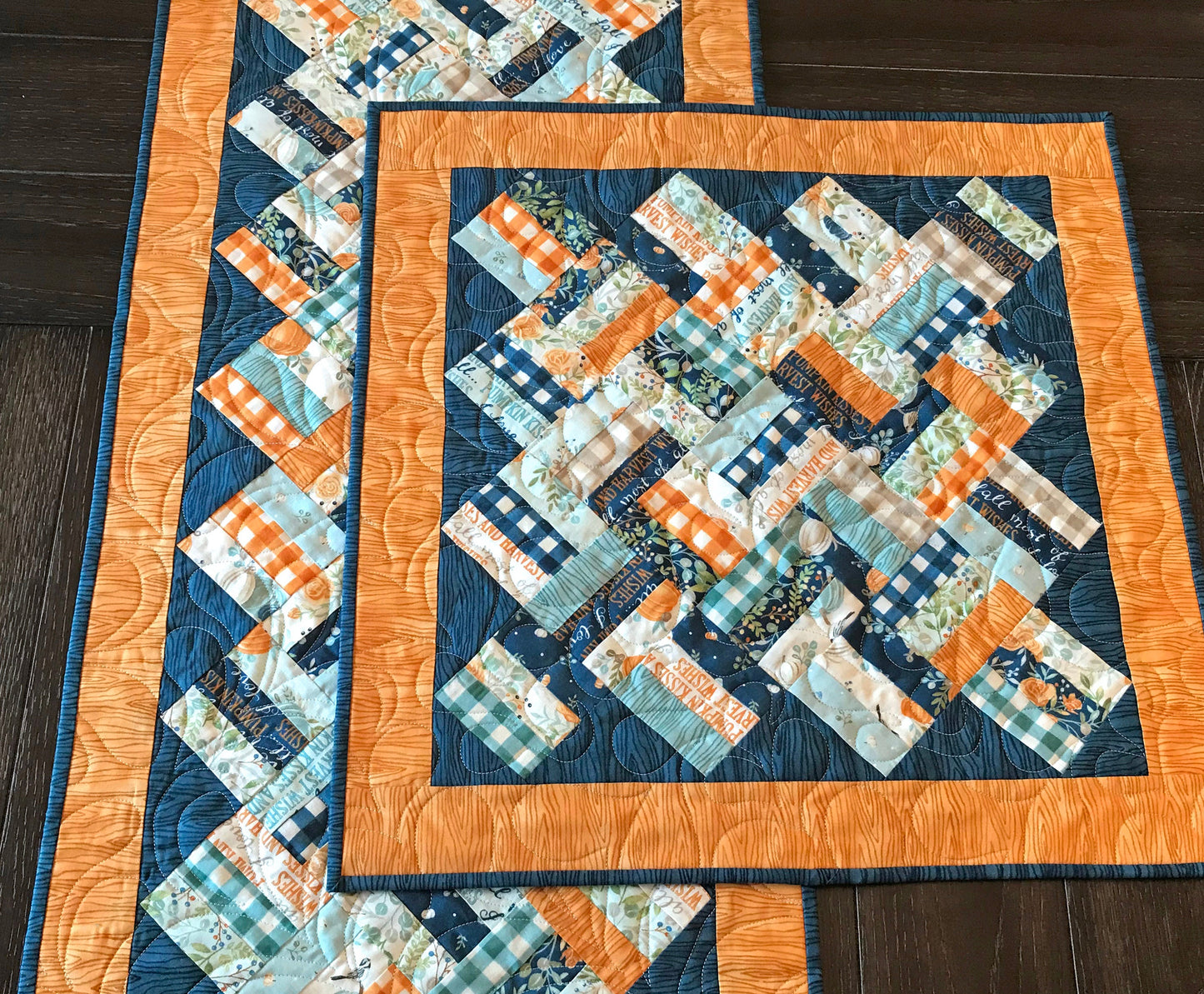 Braided Squares table runner and topper pattern. Sample runner and topper shown with a fall color scheme of dark blue, aqua, cream and orange.