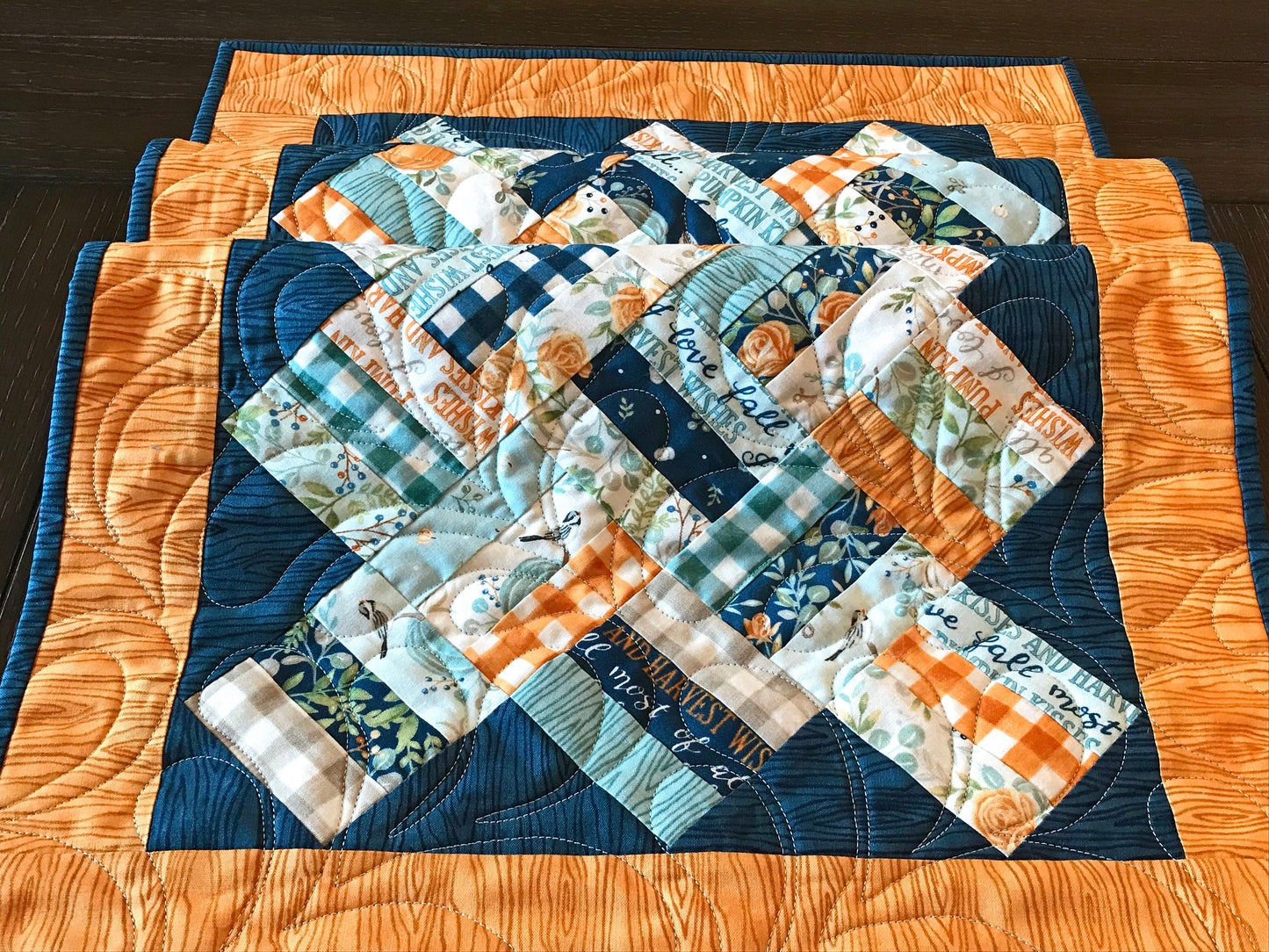 Braided Squares table runner and topper pattern. Sample runner and topper shown with a fall color scheme of dark blue, aqua, cream and orange. Close up of braided squares.